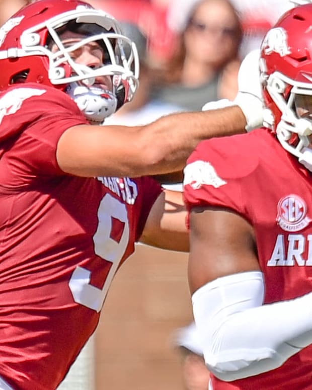 Razorbacks quarterback KJ Jefferson running behind block by Luke Hasz